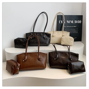 Detail view of four textured PU leather tote bags in black, beige, caramel and coffee