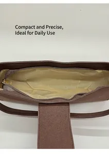 Interior view of brown leather shoulder bag showing spacious lining and zipper closure