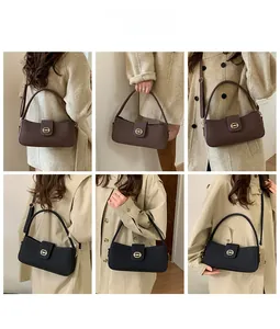Detail showing vintage suede shoulder bag with golden oval clasp and adjustable strap
