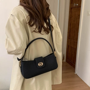 Black textured baguette shoulder bag with gold horsebit hardware shown on model