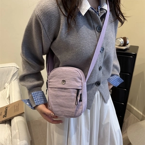 Sac bandoulière minimaliste violet clair avec logo en métal et sangle en textile