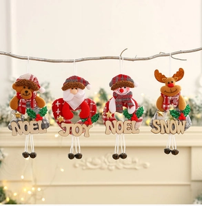 Detail of Christmas tree hanging ornaments with plush figures and metal bells