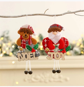 Festive Christmas fabric ornaments with NOEL and JOY wood tags on a glowing tree
