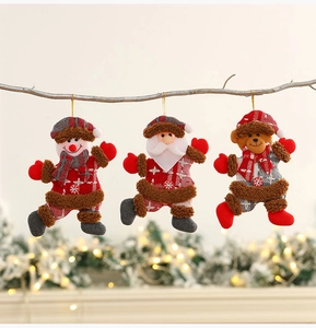 Close-up of three festive Christmas plush hangers featuring snowman, Santa, and bear