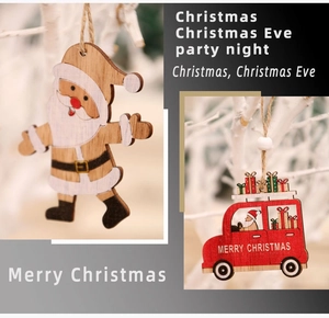 Detail of wooden Christmas ornaments featuring Santa Claus and a red gift car with twine