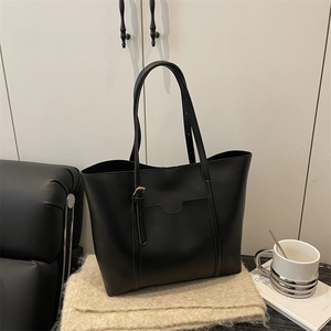 Minimalist large black PU leather tote bag with adjustable handles and a front pocket