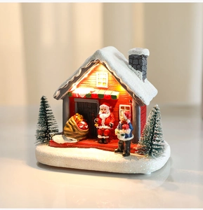 Luminous Christmas resin house with Santa Claus, mini trees and warm LED lighting