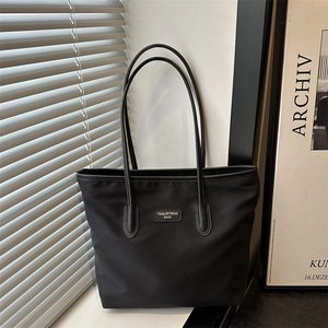 Minimalist black oxford cloth tote bag with large capacity and elegant shoulder straps