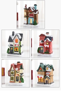 Detailed view of hand-painted resin Christmas village house miniatures with snow texture