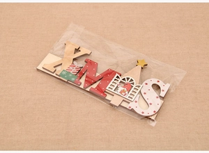Detail of DIY XMAS wooden letter blocks with festive patterns in retail plastic packaging