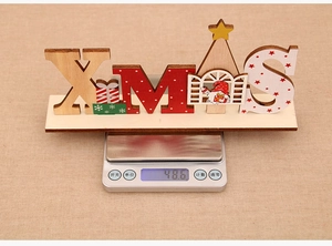 Detailed view of 48.6g wooden XMAS tabletop ornament being weighed on a scale