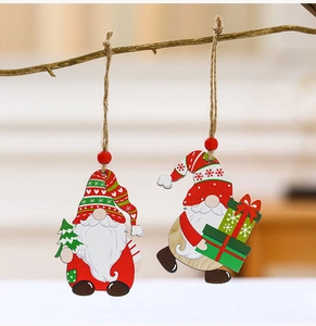 Close-up of wooden gnome ornaments with red beads hanging on branches for Christmas decor