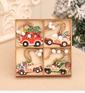 Detail of four wooden Christmas car ornaments with Santa motifs in a wooden storage box