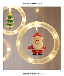 Close-up of warm white LED Christmas rings with Santa Claus and tree hanging pendants