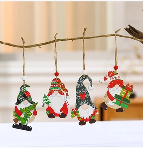 Close-up of four festive wooden Christmas gnome ornaments hanging on a natural branch