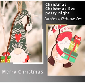 Close-up of wooden Christmas gnome ornaments with red and green painted festive details