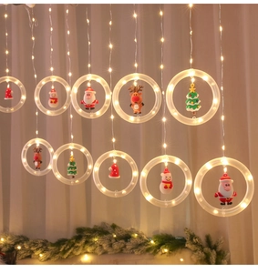 Close-up of LED Christmas curtain lights with Santa and Reindeer charms in warm glow