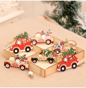 Detail of wooden Christmas car ornaments with gnomes and miniature trees in a gift box