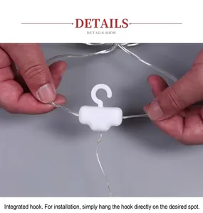 Detail of LED light string showing the white T-shape hook and transparent wiring