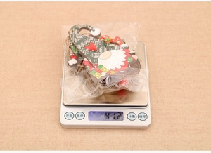 Weight measurement of 4pcs wooden Christmas gnome ornaments set with festive hemp strings