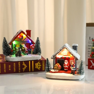 Light-up Christmas resin house ornament with warm LED lights and snowy roof detail
