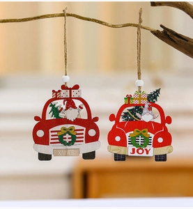 Detail of red wooden car Christmas pendants with gnomes and trees hanging on branch