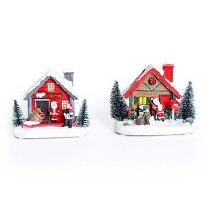 Lighted Christmas resin house set with miniature Santa Claus and snow-covered trees