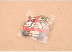 Detail of wooden Christmas ornaments featuring red truck with gnomes and JOY letters
