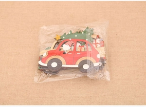 Detail view of festive wooden Christmas ornaments featuring red cars and gnomes in a set