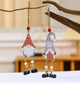 Close-up of wooden Christmas gnomes with hanging beads and boots on a branch
