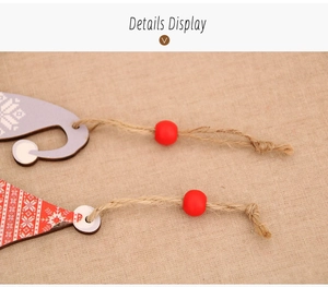 Detail of wooden Christmas gnome charms with snowflake patterns and rustic jute rope