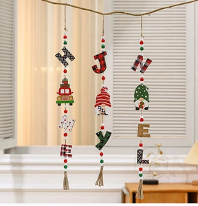 Close-up of wooden Christmas beaded pendants with truck and gnome motifs on tree branches
