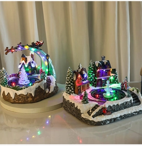 Close-up of glowing Christmas village resin scene with colorful LED lights and fountain