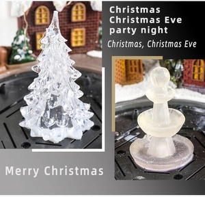 Macro detail of crystalline Christmas tree and fountain figurine for tabletop holiday decor