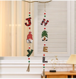 Close-up of JOY and NOEL wooden Christmas ornaments with beads and festive tassels