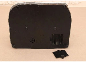 Detailed base of the Christmas music box showing battery compartment and speaker grill