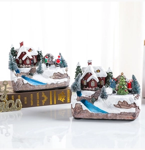 Detail of Christmas musical village house with moving skaters and snowy pine trees