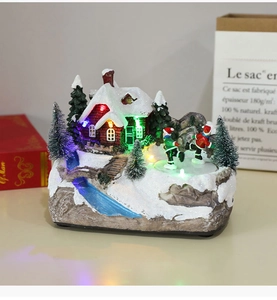 Detail of Christmas resin village with LED lights, skating figures, and snowy house décor