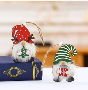 Detail of wooden Christmas gnome ornaments with plush beards and XMAS tree near blue book