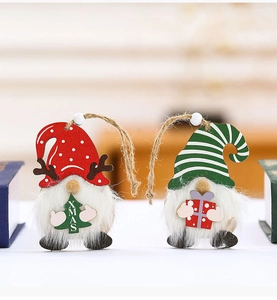 Detail of wooden Christmas gnome ornaments with plush beards and festive XMAS motifs