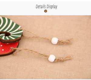 Detail of wooden Christmas gnome ornament with hemp rope, white beads and festive patterns