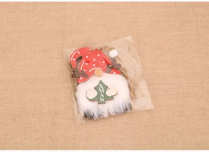 Detail of wooden Christmas gnome ornament with reindeer antlers and XMAS tree