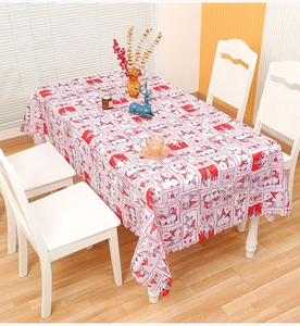 Close-up of a Christmas tablecloth featuring festive cartoon gnomes and snowflakes prints