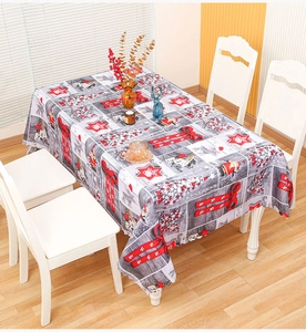 Close-up of Christmas tablecloth featuring Santa and wood grain pattern in dining room