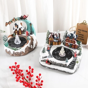 Illuminated musical Christmas village scene with rotating resin fountain and Santa sleigh