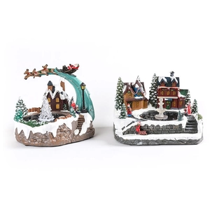 Illuminated Christmas music box fountain with rotating Santa sleigh and snow houses