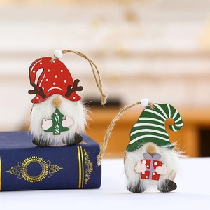 Wooden Christmas gnome pendants with reindeer antlers and XMAS tree on festive background