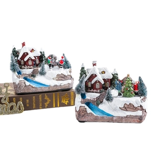Rotating musical Christmas resin ornaments featuring snowy house scenes and tiny skiers