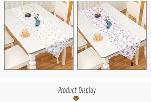 Detail of Christmas table runners with gold star patterns, wavy edges and tassels