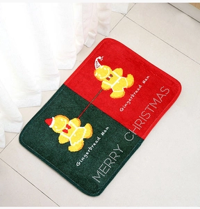 Detail of Christmas gingerbread man door mat with soft crystal velvet texture on tile floor